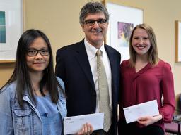 Dean Charles O'Connor presents awards to Emily Tran (left) and Taylor Mead.