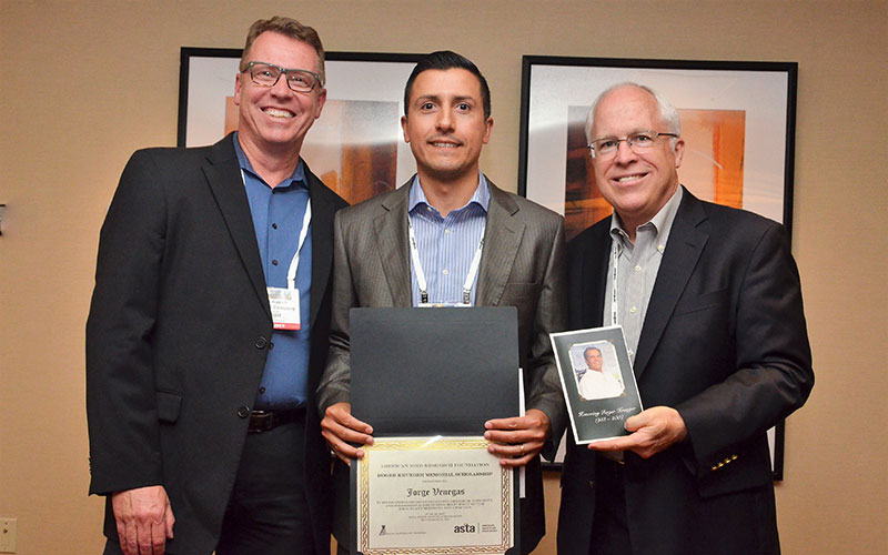 Jorge Venegas (center) receives the Roger Krueger Memorial Scholarship from Glenn Austin of the Monsanto Company (left) and Jim Tobin of the American Seed Reseach Foundation, at the American Seed Trade Association conference June 22 in Minneapolis.