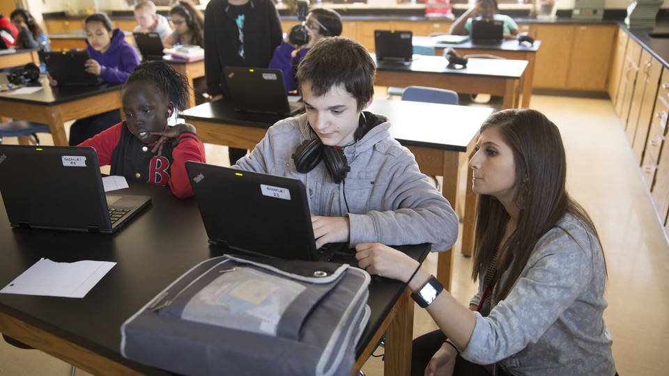 University Communications  |  In this file photo, Noyce Scholar Sarah Al-shdifat teaches science at Goodrich Middle School. A new Nebraska study found that middle-school boys who believed males are innately better at science also were less likely to say t
