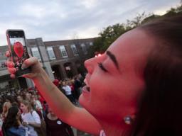  Kylie Gunderson photographs her balloon before the release during the 2016 homecoming pep rally. | Craig Chandler, University Communication