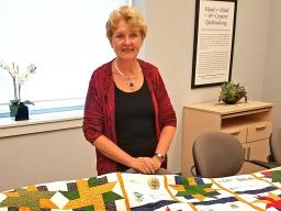 Dr. Jane Schuchardt with the quilt made in her honor by Dr. Michelle Rodgers of the University of Delaware Extension. 