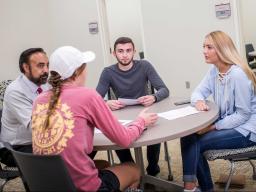 Meggan Andrade (right) talks with Dr. Ravi Sohi and other students in the Center for Sales Excellence in the new Howard L. Hawks Hall, home to the College of Business.