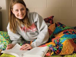 A student studies in her residence hall room.