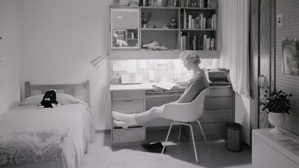 A student sits at a Cather-Pound desk in this photo taken shortly after the residence hall complex opened in 1963. The halls will be razed on Dec. 22. | University Archives