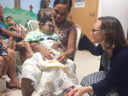Natalie Williams (right), assistant professor of child, youth and family studies, visits with a mother in Recife, Brazil. Williams is part of an international research collaboration studying how to help families affected by Congenital Zika Virus Syndrome.