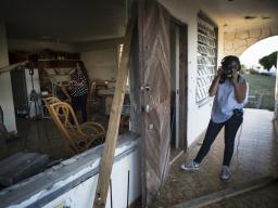 Stephanie N. Morales, in the polka dot shirt, stands in her grandmother’s house where she used to live before Hurricane Maria destroyed it. Merika Andrade worked with Ben Kreimer to reconstructed the house in virtual reality.