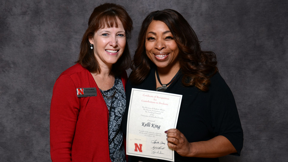 Kelli King (right), director of the William H. Thompson Learning Community, accepts her Parents' Recognition Award from Amy Goodburn, senior associate vice chancellor and dean of undergraduate education, during the Parents' Recognition Awards on Feb. 2. M