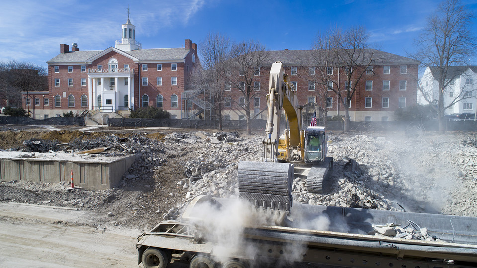 An excavator drops rubble into a truck trailer on the Cather-Pound implosion site. Data gathered during the implosion is being used to help further understand how the collapse of buildings during extreme events — like earthquakes — may affect nearby struc