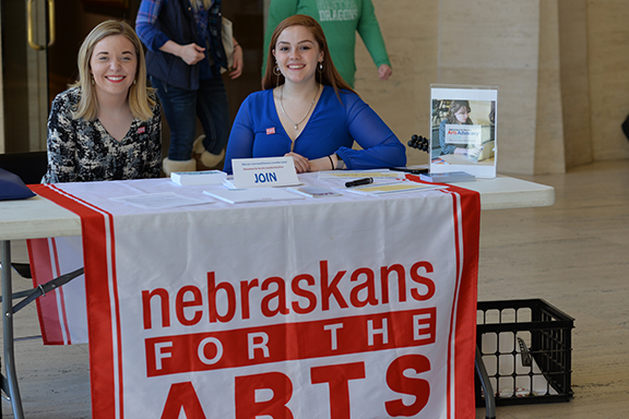 Skyler Dykes (left) and Emmalee Allen welcome participants to the Arts Advocacy Day at Sheldon on March 13. Photo by Michael Reinmiller.