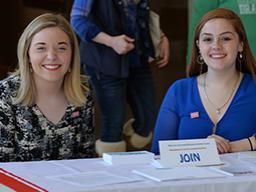 Skyler Dykes (left) and Emmalee Allen welcome participants to the Arts Advocacy Day at Sheldon on March 13. Photo by Michael Reinmiller.