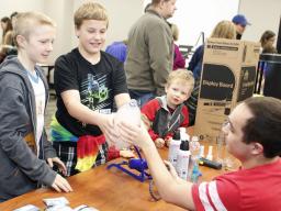 Ryland Aksamit and Terry Glantz, both of Lincoln, push “fog” out of a bottle during the 17th annual Weatherfest on Saturday, April 1, 2017, at Nebraska Innovation Campus. At right, Aiden Powers of Ceresco looks on. | Shawna Richter-Ryerson, Natural Resour