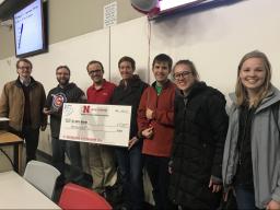 Chris Bourke (second from left) is presented the 2018 Tau Beta Pi Distinguished Teaching Award on Tuesday during a class in Brace Hall. Presenting the award were Matthew Dwyer (far left), computer science and engineering chair, and members of Tau Beta Pi.