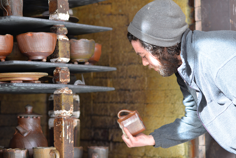 Ceramics student Kyle Cippera (BFA 2017) unloads a kiln.