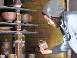 Ceramics student Kyle Cippera unloads a kiln