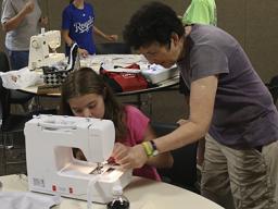 A 4-H sewing help session in 2017