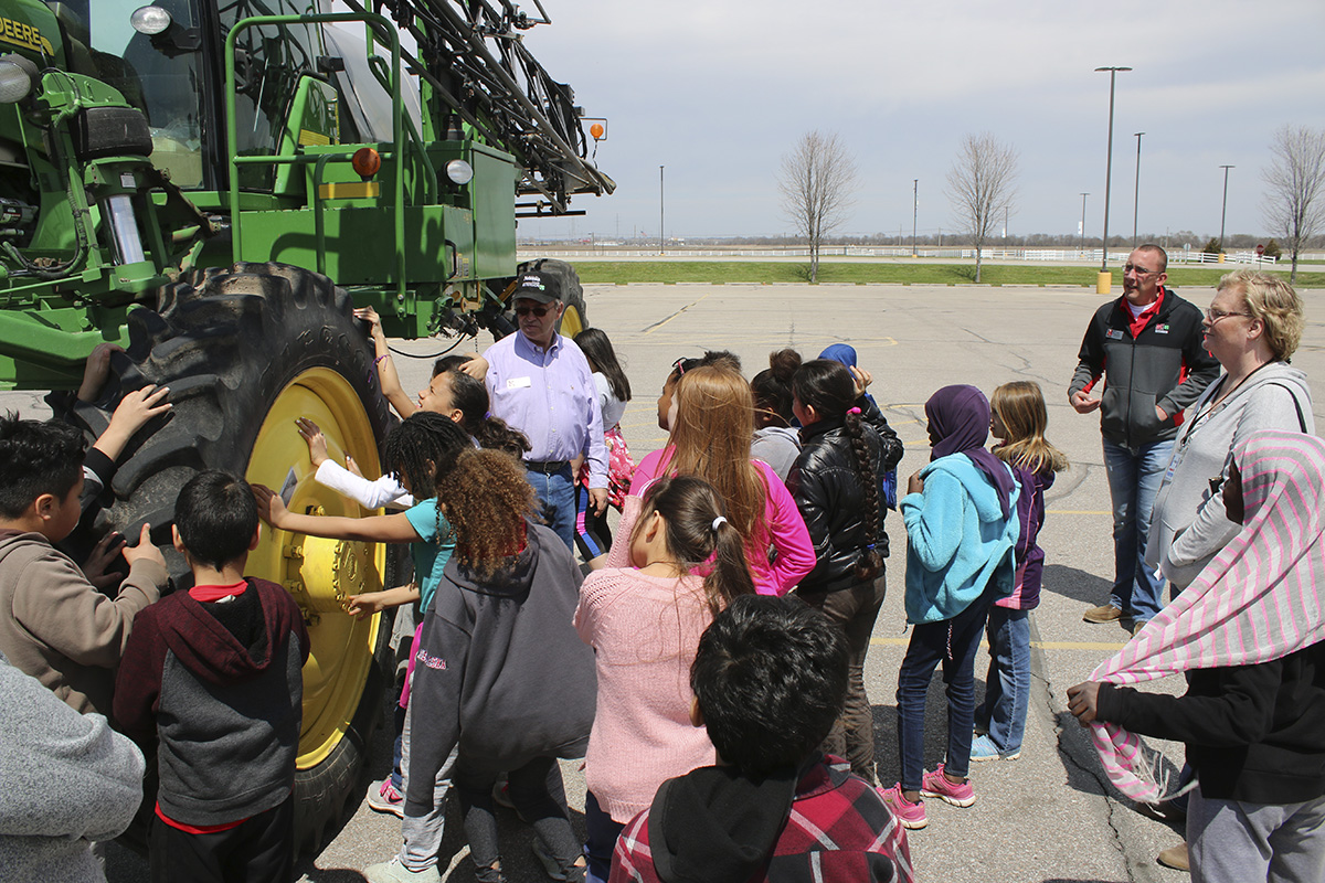 As part of farm technology, students got a close up look at a tractor and a sprayer. Extension Associate Cole Meador (at right, far back) organizes the Agricultural Literacy Festival. (Photo by Vicki Jedlicka, Nebraska Extension in Lancaster County)