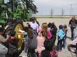 As part of farm technology, students got a close up look at a tractor and a sprayer. Extension Associate Cole Meador (at right, far back) organizes the Agricultural Literacy Festival. (Photo by Vicki Jedlicka, Nebraska Extension in Lancaster County)