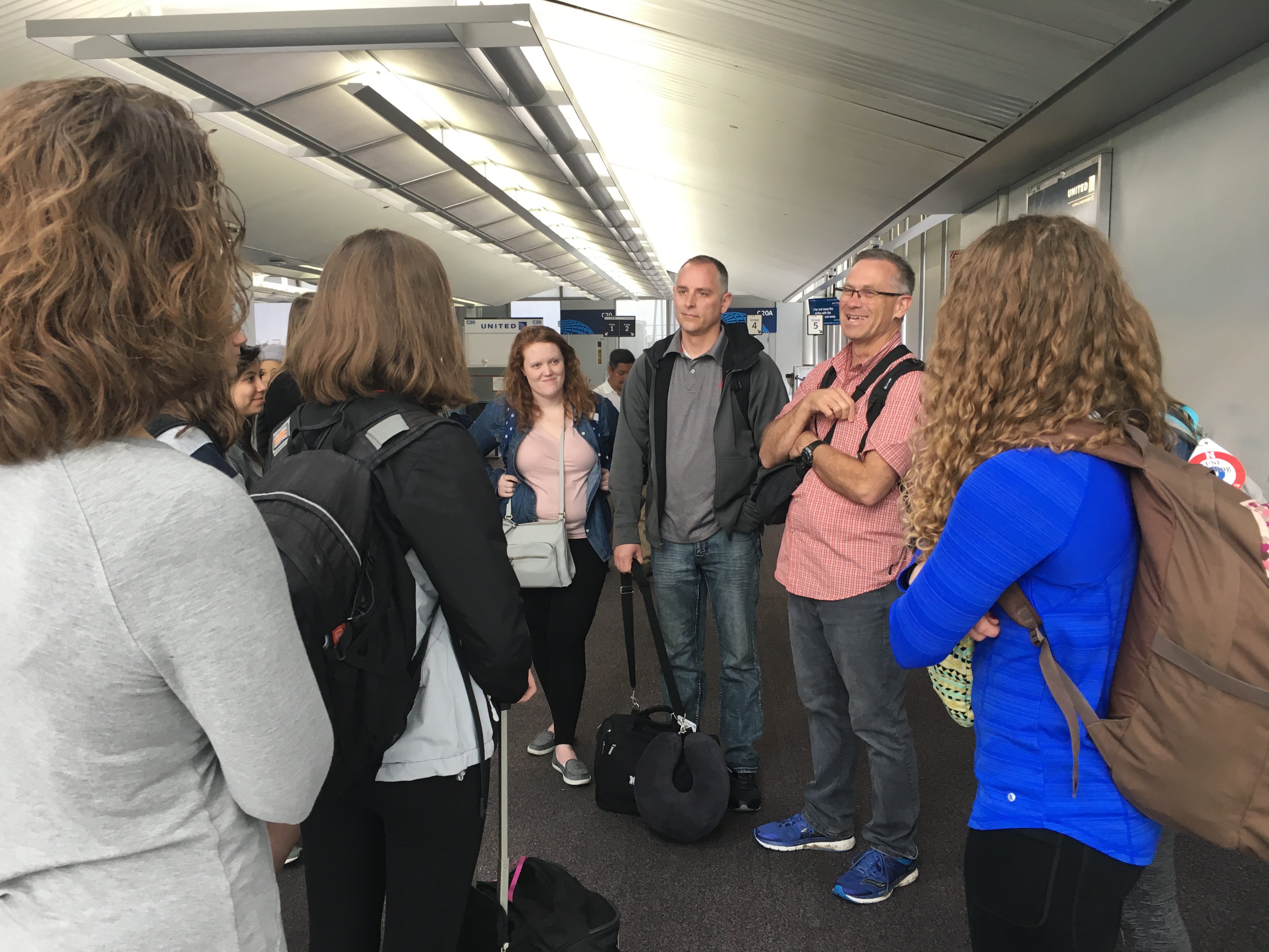 At their first stop in Chicago, Rich Bischoff (right) and Paul Springer (center) visit with students on the CYAF education abroad trip to China.