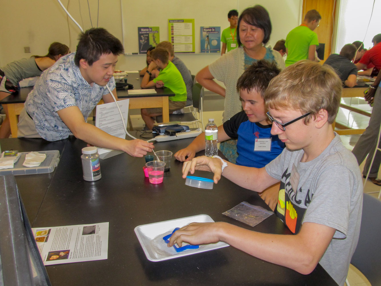 Chuyang Liu (left) and Dr. Yusong Li (right) teaching middle school students about Nano Sand.