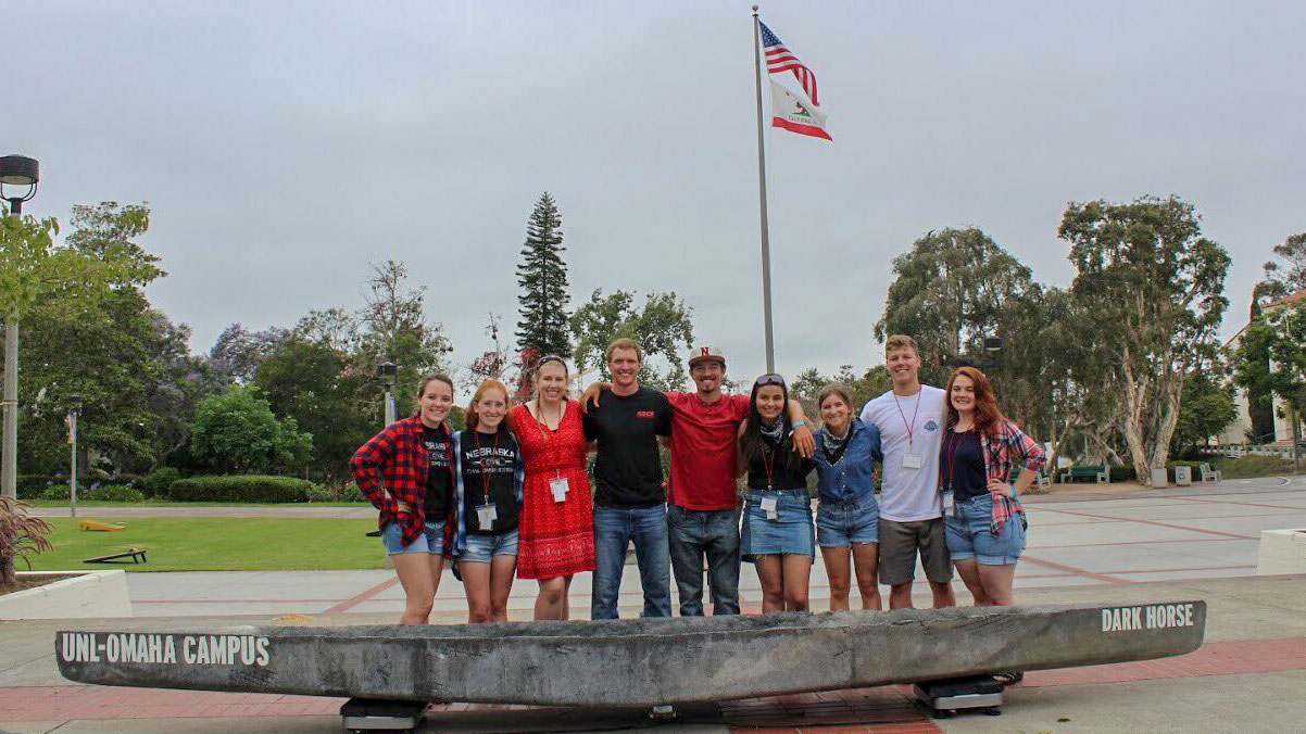 Omaha and Lincoln students weighing the canoe (l to r) Marie Wagner, Sarah Ostrander, Lizzy Humphus, Riley Ruskamp, Mike Van Hove, Nathalie Ford, Cassie Revoy, Dan Burns, and Christina Thibodeau.