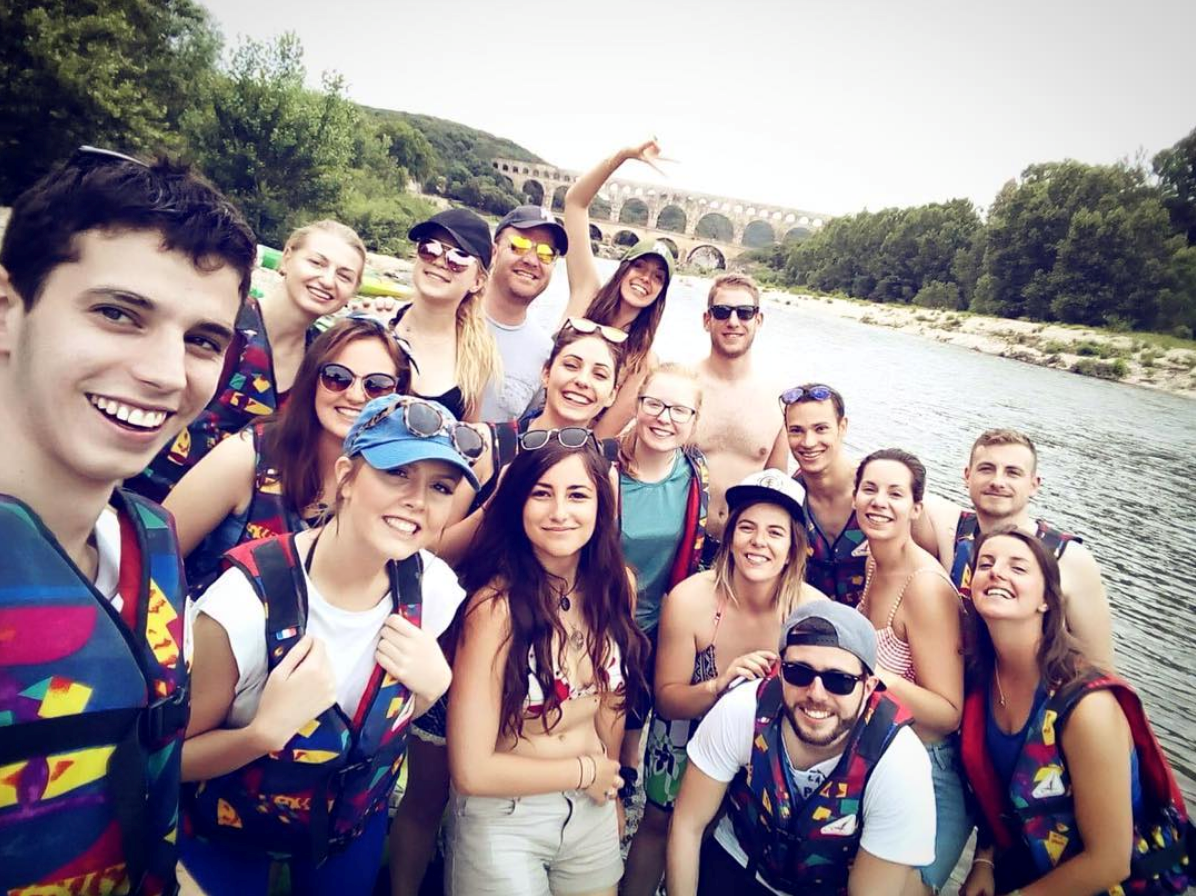 Keeleigh Thayn (second from left in front row) kayaked through the Pont du Gard with a handful of her coworkers at her internship in France.