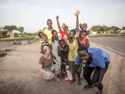 Cahner Olson poses with a group of refugee children from St. Bartholomew's Orphanage in Uganda.