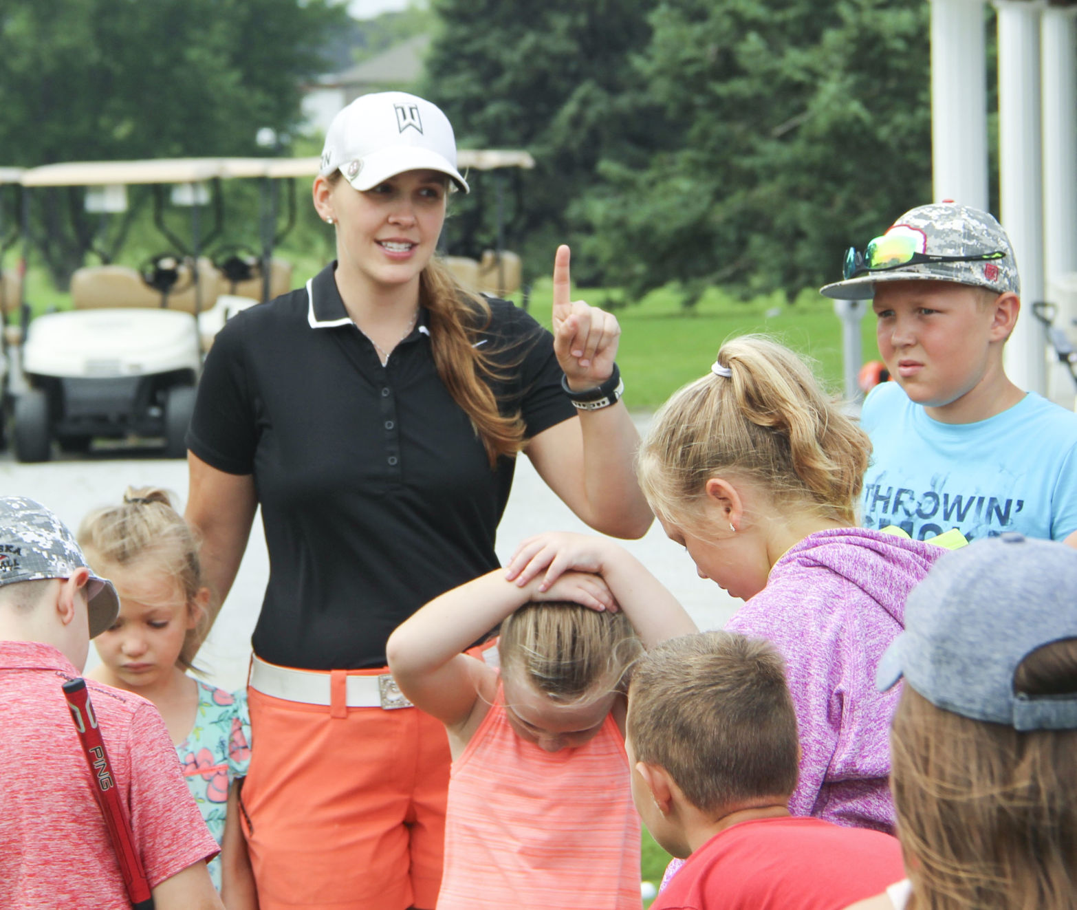 Briana Werner explains the day's activities to campers at a golf camp June 28.